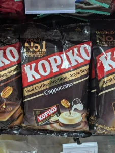 A bag of Kopiko-branded coffee hard candy. "Kopi" means coffee in the languages of Malaysia and Indonesia. The packages says "Cappuccino", meaning it is the cappuccino coffee flavor. And, it says the brand moto "Enjoy Coffee Anytime, Anywhere". In the upper left-hand corner it says "World's Number one coffee hard candy".