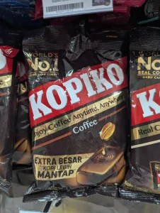 A bag of Kopiko-branded coffee hard candy. "Kopi" means coffee in the languages of Malaysia and Indonesia. The packages says "Coffee", meaning it is the regular coffee flavor. And, it says the brand moto "Enjoy Coffee Anytime, Anywhere". In the upper left-hand corner it says "World's Number one coffee hard candy".