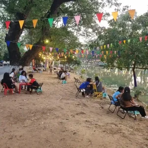 A camping-themed café along a river with seating in Cambodia.