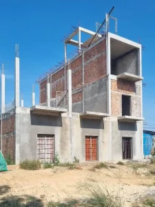 An image showing the construction method in Southeast Asia for building buildings. This building is still under construction. A concrete skeleton (visible in this image) was constructed on a foundation. Then, brick was laid to fill in the skeleton, building the outer and inner walls of the building. Finally, concrete is smeared over the brick and smoothed out for a smooth texture. Some skeleton sections of the building are filled in with brick, other sections are not. So, the skeleton with rebar sticking out is visible.