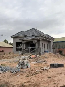 A house made out of concrete in Southeast Asia. The house is still under construction - the structure is finished, but windows, a door, painting, and interior finishing needs to be done.