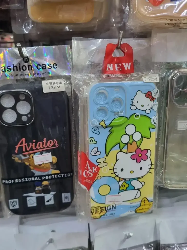 iPhone phone case. A phone cute case for iPhone sold in Southeast Asia. It has a mural of Hello Kitty on an island consisting of sand (in a yellow solid color), a tree with three coconuts on it, and ocean water (in a solid light blue color). It says "Happy" on it.