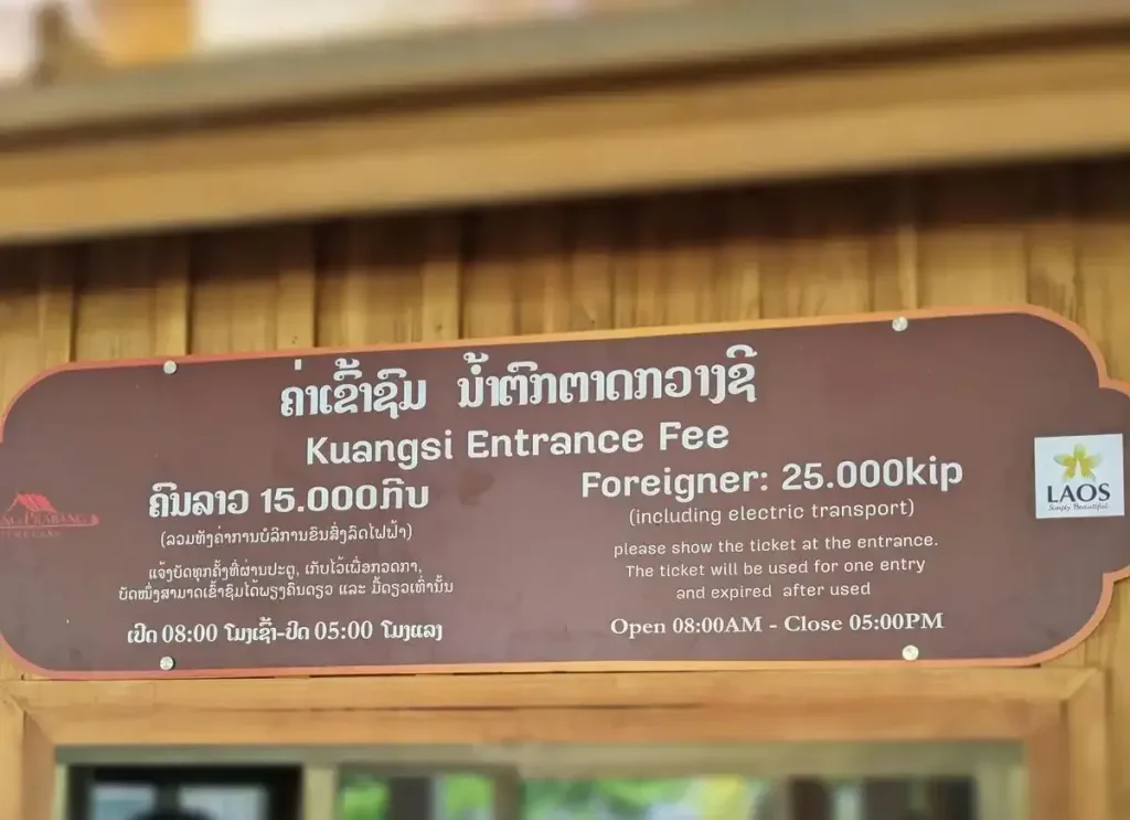 A sign at a national park ticket booth with entrance fees and opening times for the Kuangsi Waterfall area in Luang Prabang, Laos with different prices for locals and foreigners. The local price is fifteen thousand Laos Kip (about seventy-five cents in US dollars), and the foreigner price is twenty-five thousand Laos Kip (about one US dollar). While the price difference is not much in this image, and can be justified at times, price differences for foreigners can be much greater throughout Southeast Asia. This image is the only image the author has on file, currently, as a representative example to illustrate how charging foreigners, often times, a very high price without justification is common place in Southeast Asia. Further examples include food menus at restaurants, hospital services, and purchases without price tags ... all of which have different prices for locals and foreigners. Locals pay the local price, and foreigners pay a price of 2, 3, 5 or 6, and at times as much as 10 times higher than the local price. For context, it is nearly impossible for foreigners to immigrate to a Southeast Asia country, and therefor they have no rights or protections in the region. An us (local) vs them (foreigners) mentality shows itself by means of this accepted practice of dual pricing.