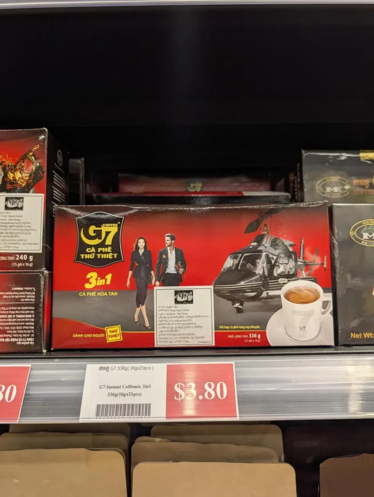 A box of Vietnamese G7-branded three-in-one instant coffee for sale at a grocery store. There are twenty-one packets of it, weight sixteen grams each. Price is three US dollars and eighty US cents.