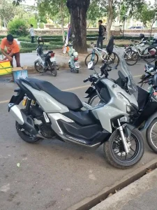 A Honda ADV 160cc automatic motorbike in Southeast Asia. It is parked along the road.