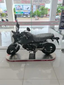 A Honda Grom manual motorbike at a dealership in Cambodia. This is a brand new bike.