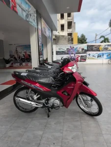 A Honda Wave 110 cc semi-automatic motorbike at a dealership in Cambodia. This is a brand new bike.