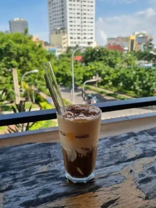 An image of an iced egg coffee in a café in Vietnam called Little Hanoi Cafe. Egg coffee is similar to a late, but with cream that includes egg in it's ingredients, instead of steamed milk. It does not taste like egg.