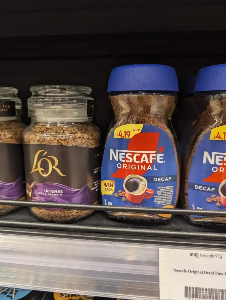 A container of Nescafe-branded instant coffee for sale at a grocery store. The total weight is ninety-five grams.