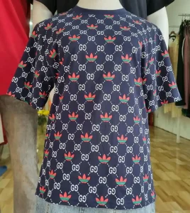 A knock-off t-shirt with Adidas and Gucci logos imprinted on it.