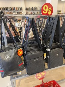 Fake Gucci-branded and Armani-branded bags for sale for nine US dollars in Southeast Asia.