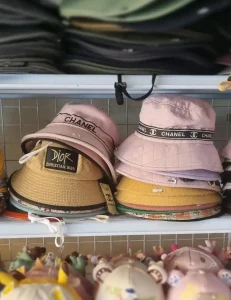 Cambodian bucket hats. Some hats have fake Chanel branding, others have Christian Dior branding.