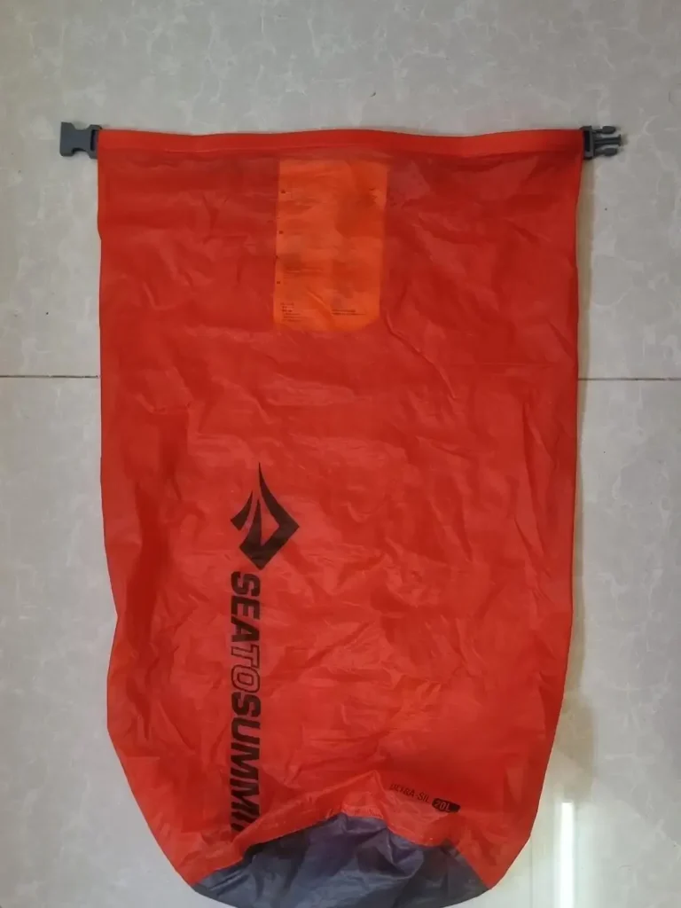 A large stuff sack by Sea To Summit brand. It is water-resistant, not waterproof, and is large enough to old a large laptop. The sack will not hold a perfect air-tight seal for a long period of time. There is only 1 opening, the flap of the sack, which has clips sewn on the left and right-hand sides. The way it is closed is by rolling the opening/flap of the sack, and then clipping the two clips together.