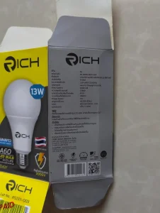 The box for a thirteen watt LED lightbulb sold at Mr. DIY store in Thailand. The box shows the specifications of the lightbulb. To highlight, the important specs are that it is thirteen watts, and that the brightness is one hundress lumens per watt. The LED bulb has a plastic cover, instead of glass like a incandescent would have, which makes it ideal for traveling with. That's to say, glass break and plastic does not, so this LED bulb with plast cover is better.
