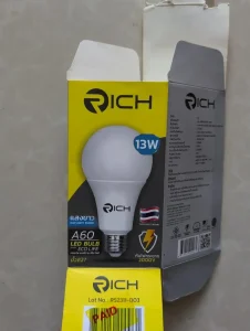 The box for a thirteen watt LED lightbulb sold at Mr. DIY store in Thailand. The box shows the specifications of the lightbulb. To highlight, the important specs are that it is thirteen watts, and that the brightness is one hundress lumens per watt. The LED bulb has a plastic cover, instead of glass like a incandescent would have, which makes it ideal for traveling with. That's to say, glass break and plastic does not, so this LED bulb with plast cover is better.