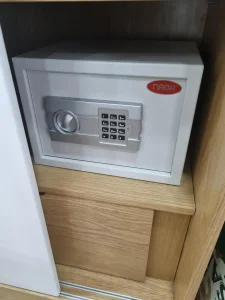 A lockbox safe found in accommodation such as a hotel, apartment, or home. The lockbox has a digital key-pin to unlock it.