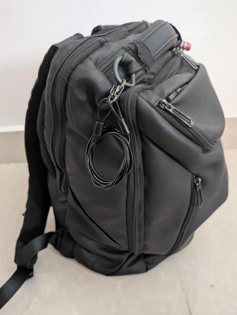 This is a Mark Ryden branded 30 liter backpack with main 3 compartments. Attached is a TSA 4-pin travel lock metal to lock the zippers. Also a travel cable is clipped on, which can be used for locking and tethering the bag to an anchor object to prevent anyone from stealing the bag.