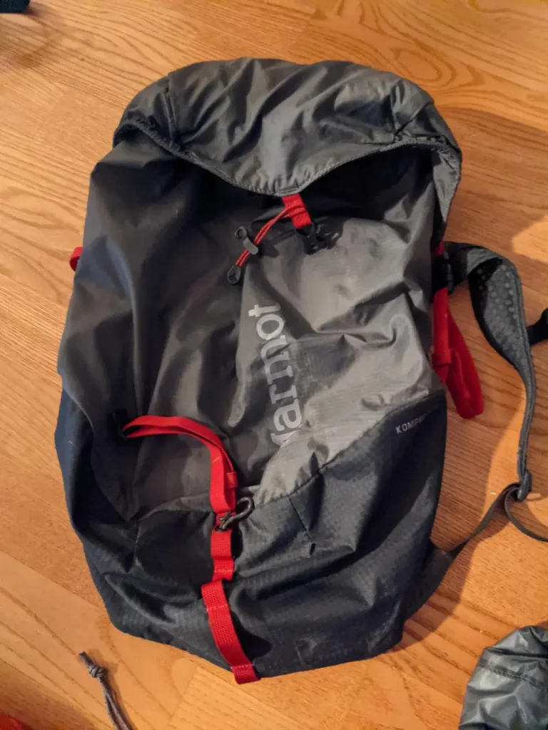 Front view of an empty 18 liter day bag. This bag is lightweight, and made by Marmot brand.