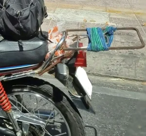 A rear rack mounted on a motorbike in Vietnam. The motorbike is a Detec Honda Win.