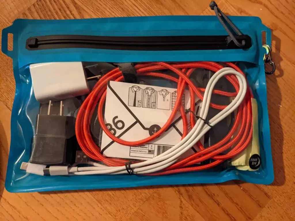 A waterpoof pouch to protect valuables, and have better organization while adventuring. This pouch is made of waterproof material, and has a special zipper design to seal it, water-tight. This also prevent typical dirt and debri getting inside the pouch. This pouch is a flat, and is about 7 inch by 10 inch in size. The picture shows various valuables inside such as electronics, cell phone, etc, passport, etc.
