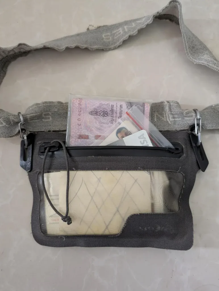 Nite Ize branded waterproof wallet that is concealable under clothing by using an attached elastic belt with valuables inside. Valuables include cash, IDs (identification cards), credit/debit cards, etc.