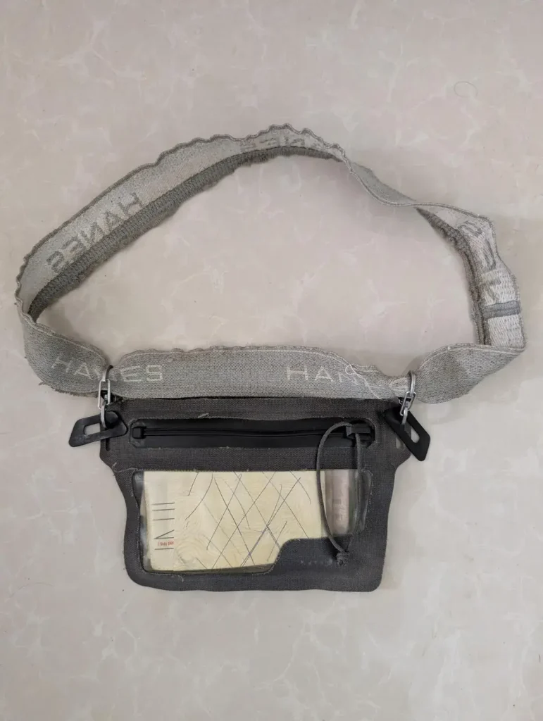 Nite Ize branded waterproof wallet that is concealable under clothing by using an attached elastic belt.