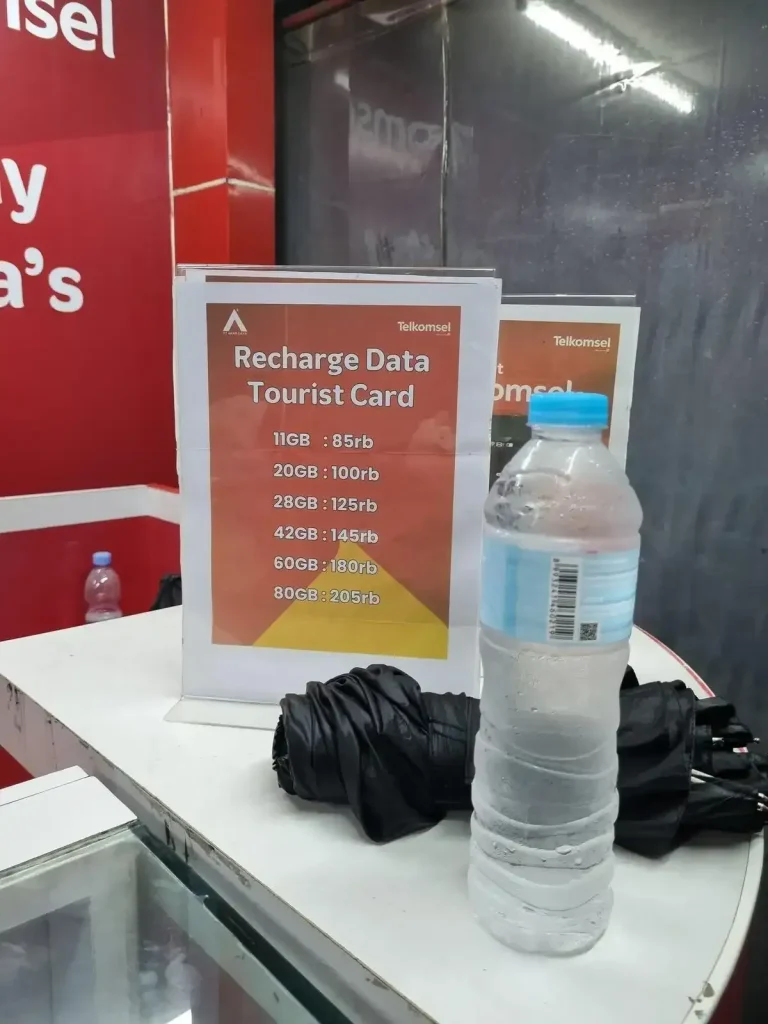 A price list for tourist sim cards as a Telkomsel mobile kiosk in Indonesia. Options are eleven giga bites for eight-five rupiah, twenty giga bites for one-hundred rupiah, twenty-eight giga bites for one-hundred and twenty-five rupiah, fourty-two giga bites for one-hundred and fourty-five rupiah, sixty giga bites for one-hundred eighty rupiah, and eighty giga bites for two-hundred and five rupiah.