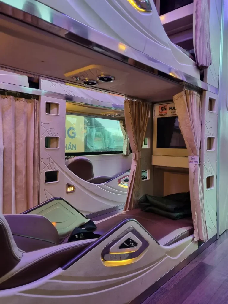 Sleeper bus in Vietnam that is 3 beds wide. The center bed has 2 rows on each side. The bus width is bed, row, bed, row, bed.