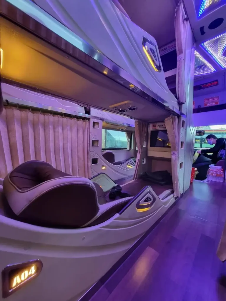 Sleeper bus in Vietnam that is 3 beds wide. The center bed has 2 rows on each side. The bus width is bed, row, bed, row, bed.