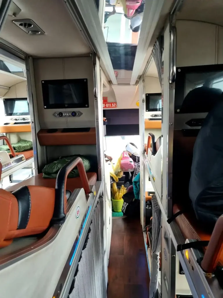 Sleeper bus in Vietnam that is 3 beds wide. The center bed has 2 rows on each side. The bus width is bed, row, bed, row, bed.