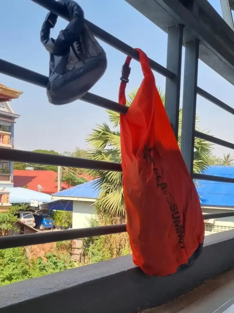 Two stuff sacks, a small and a large one, clipped onto a railing. This is to demonstrate that how they can be clipping anywhere for convenience.