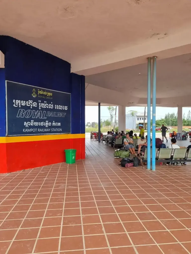 Passenger waiting area at the Kampot Cambodia train station. The station is open-air with no walls on the font and rear. This allows a cool breeze to flow through it on a hot day.