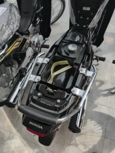 Under seat storage compartment on a Honda Dream semi-automatic motorbike. The gas tank lid is located under the seat, too.