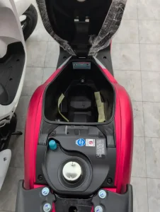 Under seat storage compartment on a Honda Scoopy automatic motorbike. The gas tank lid is located under the seat, too.