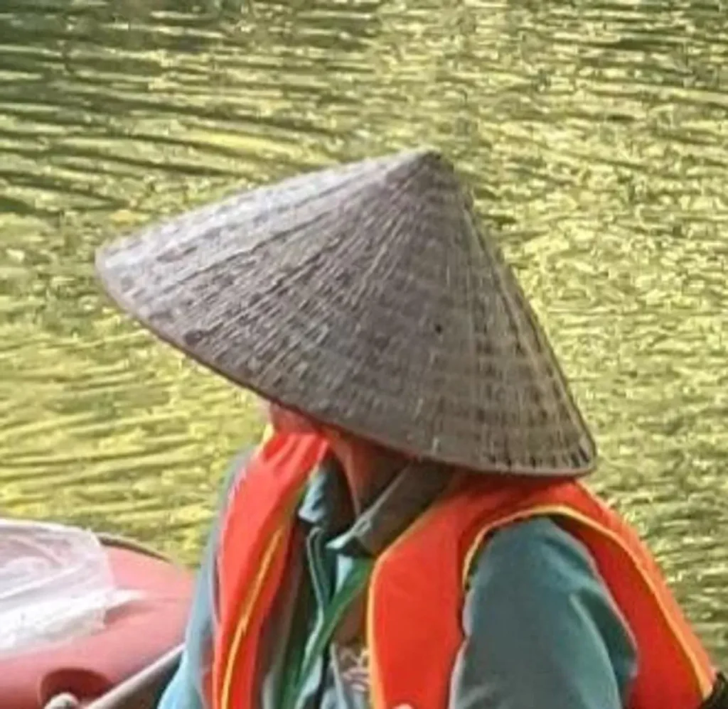A Vietnamese-style straw hat. These are hand-made. Thai, Khmer (Cambodian), and Vietnamese straw hats all different. Vietnamese are conical, while Cambodian staw hats are like a bucket hat. The Thai version are similar to the Cambodian one, but with some hard-to-describe shape differences.