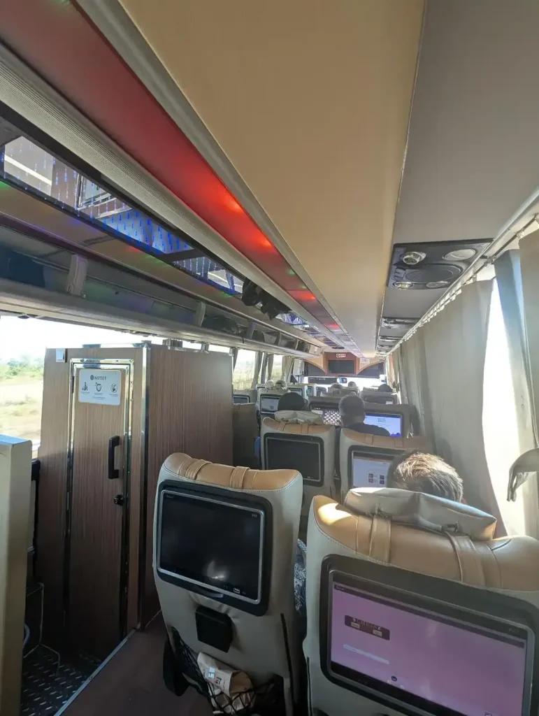 VIP bus that can be taken between cities or do a land border crossing from one country to another in Southeast Asia. Inner cabin with toilet to the left.