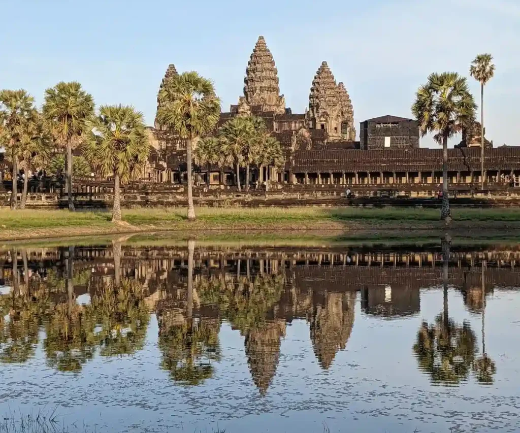 Angkor Wat temple within Angkor Archaeological Park, which is a UNESCO World Heritage Site. This image is at the a retention pond, located in front of the west side of Angkor Wat. The temple can be seen, along with it's reflection of the water, providing a mirror-like image.