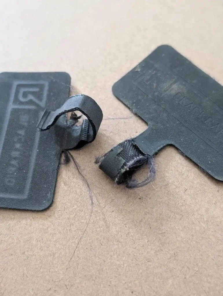 Worn out and broken BlackRapid-brand tether tabs. This is meant to show how tether tabs are working hard for you, and over time they break. This image is also to reinforce the recommendation to buy a three-pack to have spares if & when your tether tab breaks.