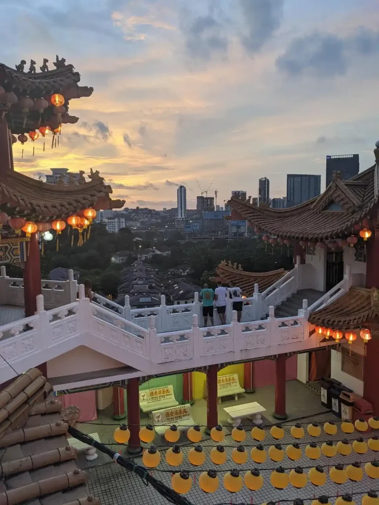 A city view at a temple in Kuala Lumpur, Malaysia. The temple is on a hill within the city. This image is taken at the back end of the temple, so part of the temple is in the foreground, while the city view is in the background.