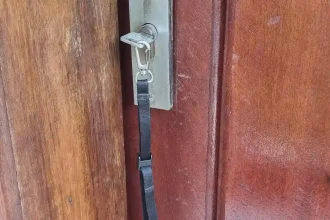A small tether leash (essentially a small lanyard) with a key attached. This leash is made by BlackRapid, which is made for tethering a smartphone, but can be used for a key, too. The leash has a quick-attach hook (similar to a rock climbing clip) on one end that the key is attached to, and locking clip on the other end. The locking clip is adjustable. For example, you can slide a belt through the leash, unlock the clip, and slide the clip tight with the belt, and then lock the clip. This is great to ensure that the leash is tethered to something (your belt in this case) and cannot be lost easily.