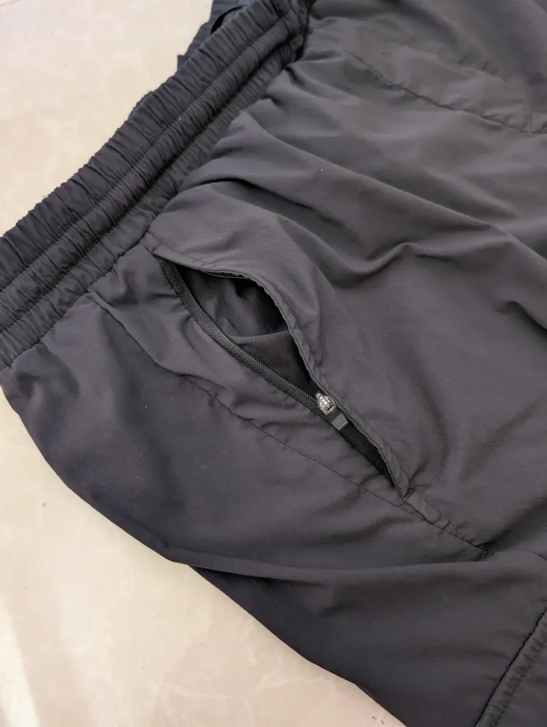 A pair of long pants that have zipper pockets. Having a zipper pocket prevents loosing things.