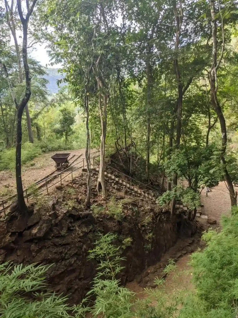 A view looking down on the hellfire pass at it's most popular point where prisoners of war were force by Japanese soldiers to chisel through a large rock area and lay railway track. This rock area has steep and high walls, which are up to twenty-five meters deep and seventy-five meters long. On top of the rocky area is a cart on a track, which demonstrates how the prisoners carted-away the rock they chiseled out. Located in Kanchanaburi, Thailand