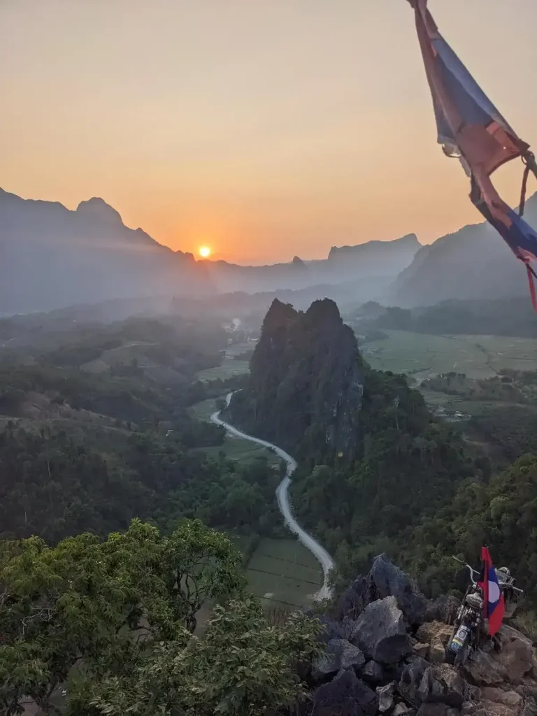 A mountain hiking viewpoint with sunset at Nam Xay Viewpoint in Vang Vien, Laos.