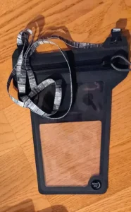 A waterproof phone pouch made by Nite Ize. It comes with a lanyard attached, which is shown in the image. This waterpoof pouch is to protect a phone & any other valuables you put inside of it. This pouch is made of waterproof material, and has a special zipper design to seal it, water-tight. This also prevent typical dirt and debri getting inside the pouch. This pouch is a flat, and is big enough in size to fit a larg-sized smart phone.