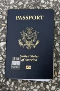 A USA passport. It reads "PASSPORT" at the top, and "United States of America" at the bottom. The middle has an emblem.
