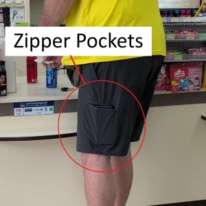 A person wearing shorts with a side cargo pocket that has a zipper on it. Having a zipper pocket prevents loosing things.