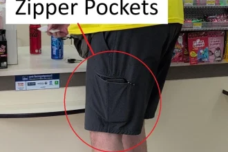 A person wearing shorts with a side cargo pocket that has a zipper on it. Having a zipper pocket prevents loosing things.