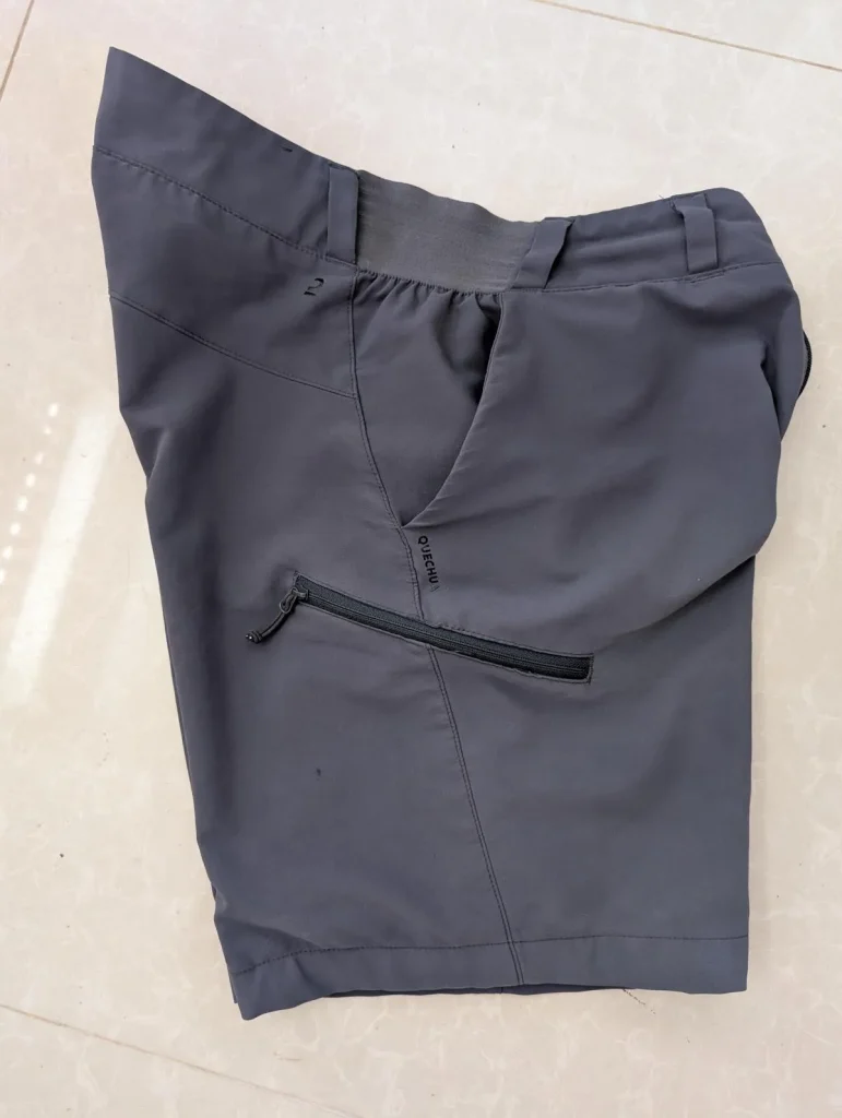 A pair of shorts with a side cargo pocket that has a zipper on it. Having a zipper pocket prevents loosing things.