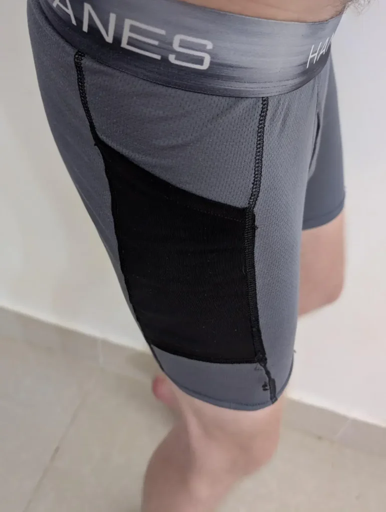 Pocket on underwear. A pair of spandex underwear that has a built-in storage pocket on the right-hand leg side.