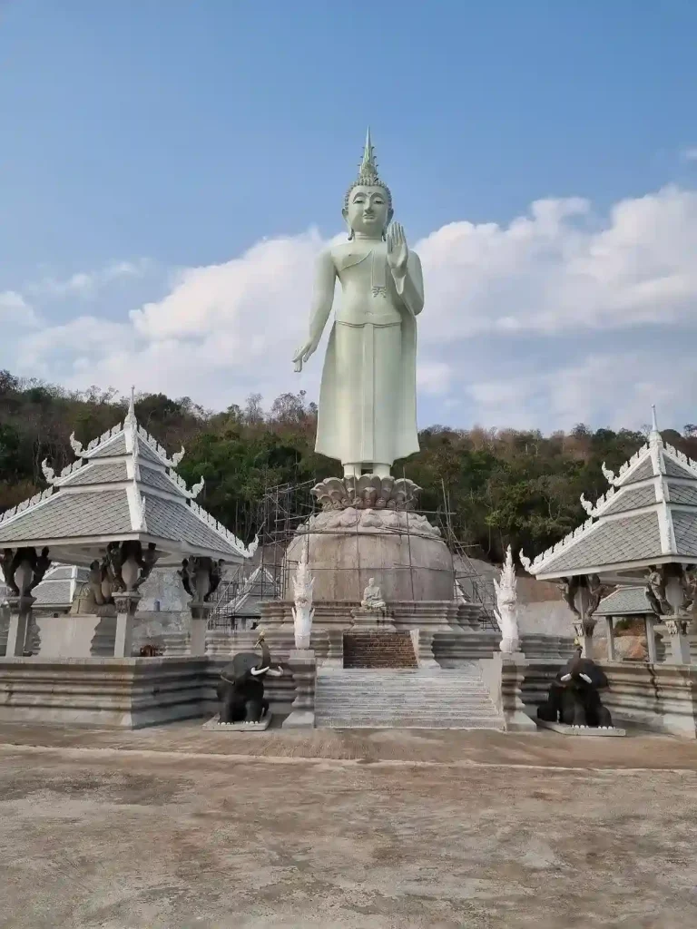 A tall buddha statue at a temple in rural Thailand.